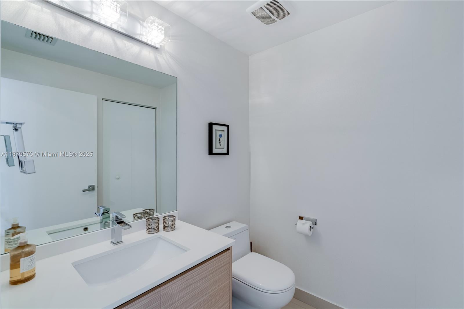 600 Northeast 27th Street, Unit 2801 Miami, FL 33137 - Photo 39 of 48 a bathroom with a sink mirror vanity and toilet
