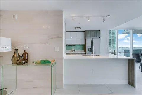 a kitchen with stainless steel appliances granite countertop a sink and cabinets