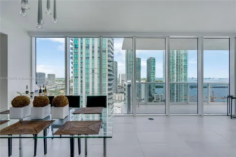 a living room with furniture and a floor to ceiling window