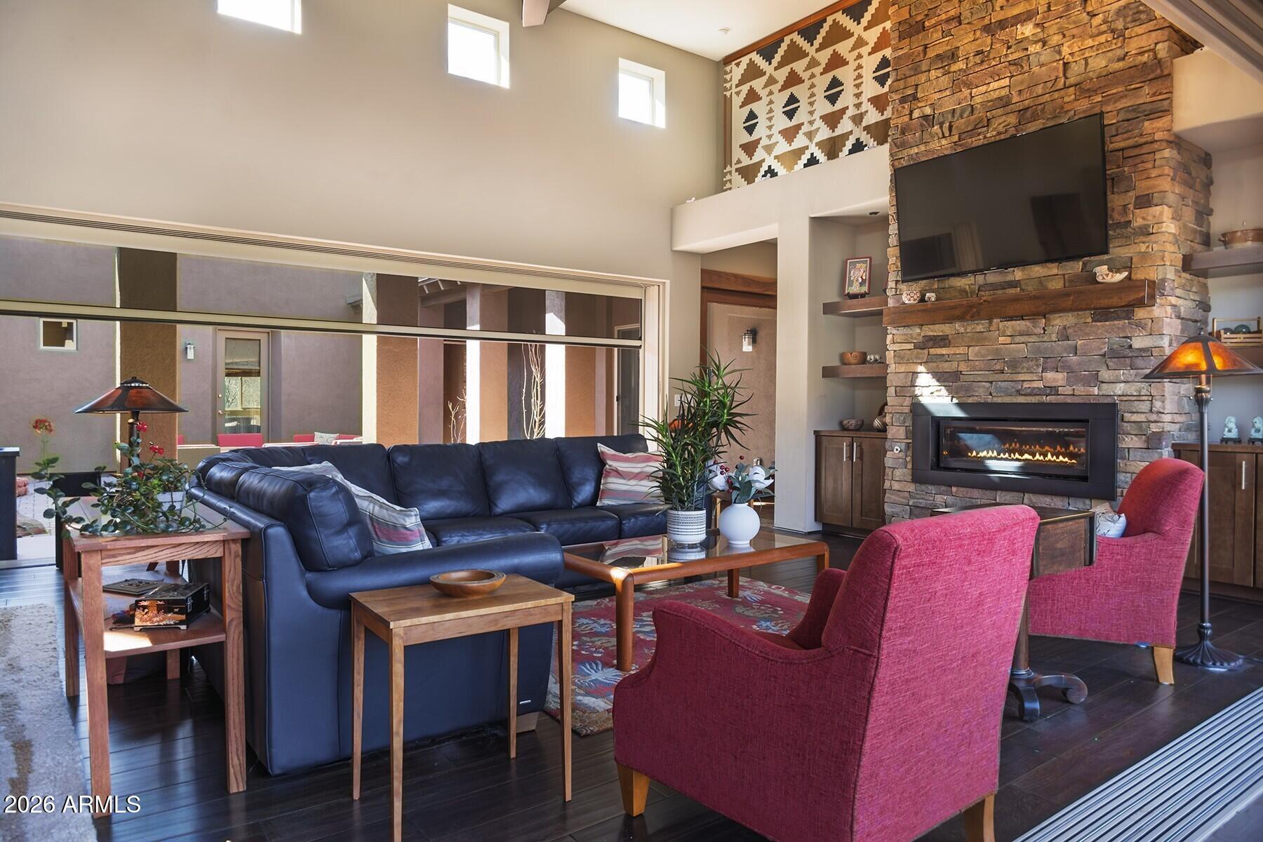 25 Cathedral Ranch Drive Sedona, AZ 86351 - Photo 12 of 40 a living room with furniture a flat screen tv and a fireplace