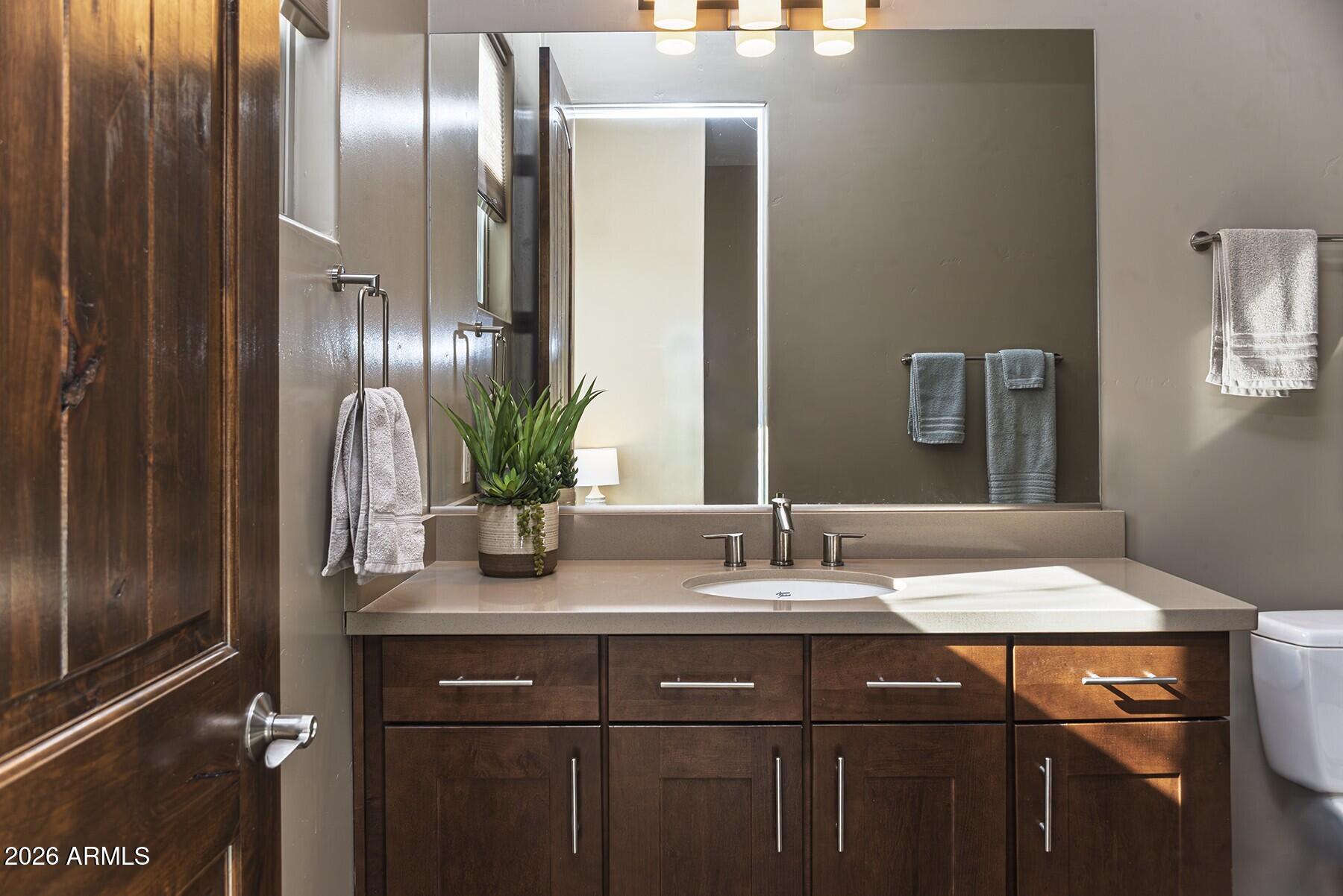 25 Cathedral Ranch Drive Sedona, AZ 86351 - Photo 30 of 40 a bathroom with a granite countertop sink a potted plant and a mirror