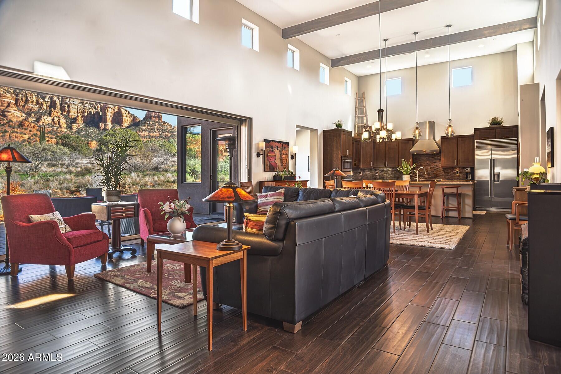 25 Cathedral Ranch Drive Sedona, AZ 86351 - Photo 9 of 40 a living room with furniture a large window and wooden floor