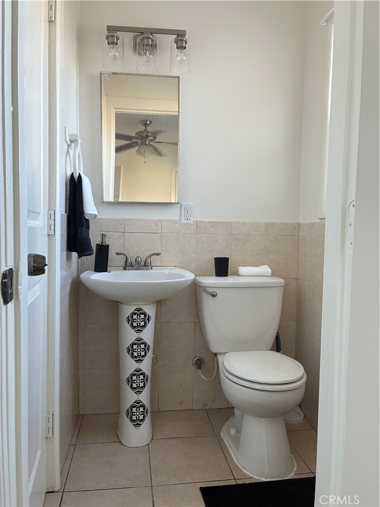 1326 East 15th Street Santa Ana, CA 92701 - Photo 11 of 21 a bathroom with a toilet sink and mirror