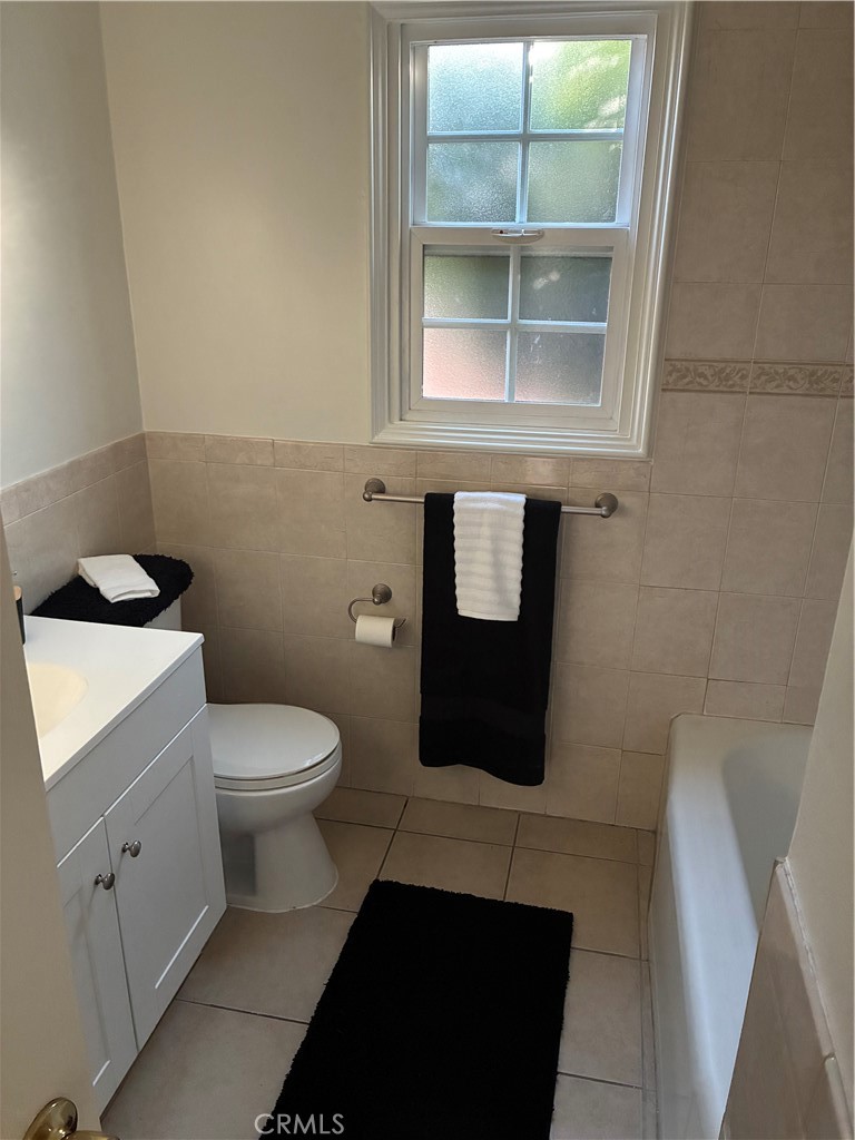 1326 East 15th Street Santa Ana, CA 92701 - Photo 12 of 21 a bathroom with a toilet and a window