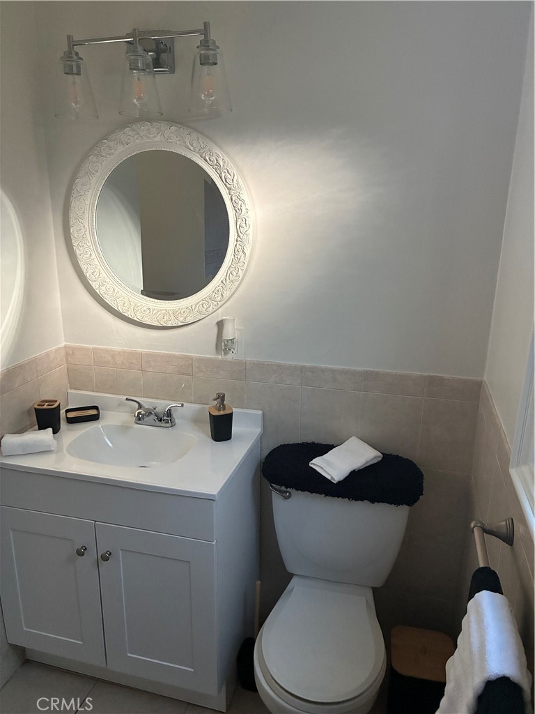 1326 East 15th Street Santa Ana, CA 92701 - Photo 13 of 21 a bathroom with a toilet sink and mirror