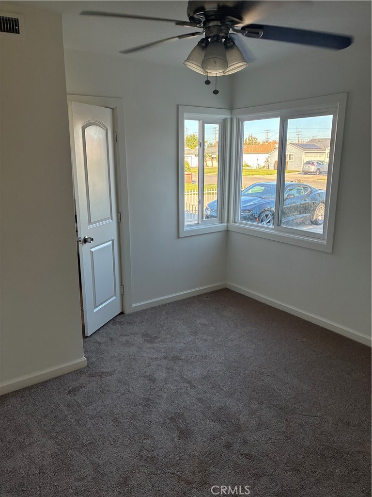 1326 East 15th Street Santa Ana, CA 92701 - Photo 16 of 21 an empty room with windows and chandelier fan