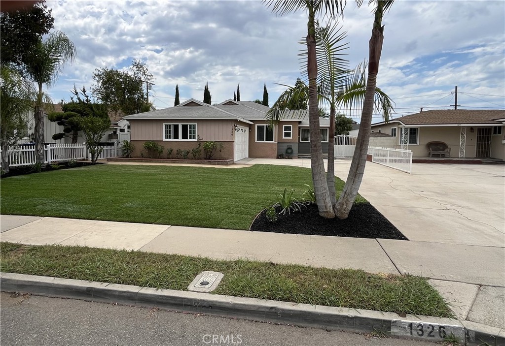 1326 East 15th Street Santa Ana, CA 92701 - Photo 2 of 21 a front view of a house with a garden