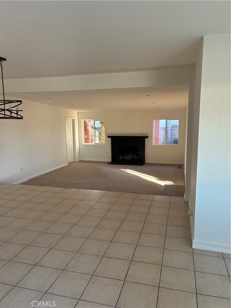 1326 East 15th Street Santa Ana, CA 92701 - Photo 7 of 21 a view of empty room with fireplace and windows