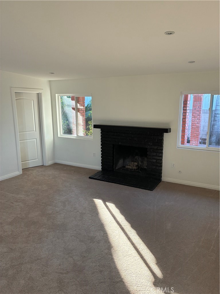 1326 East 15th Street Santa Ana, CA 92701 - Photo 8 of 21 a living room with furniture and a fireplace