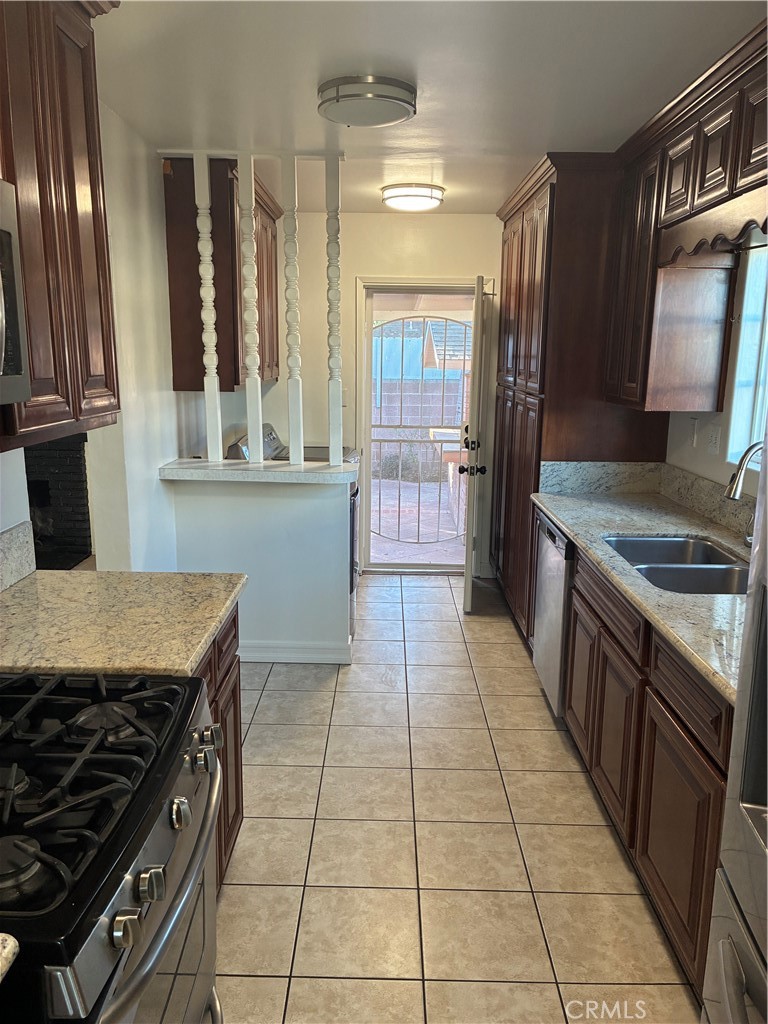 1326 East 15th Street Santa Ana, CA 92701 - Photo 9 of 21 a kitchen with a stove top oven and cabinets
