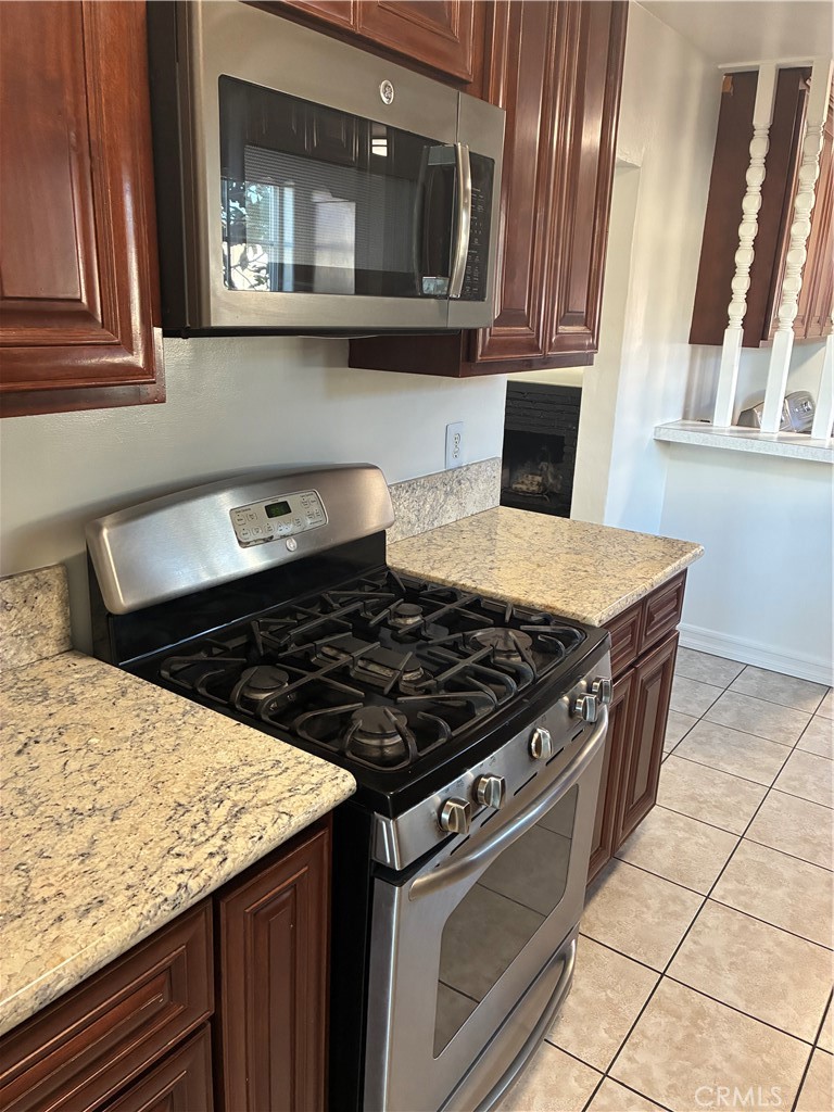 1326 East 15th Street Santa Ana, CA 92701 - Photo 10 of 21 a kitchen with granite countertop a stove and a sink