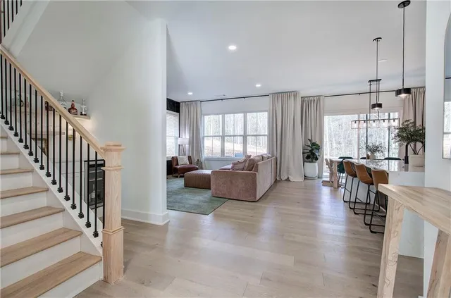 a view of a living room and dining room with wooden floor