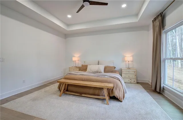 a spacious bedroom with a large bed and a chandelier