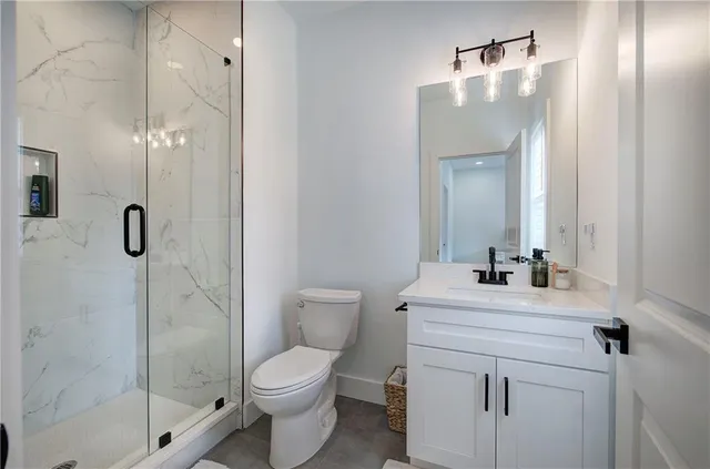 a white toilet next to a bathroom