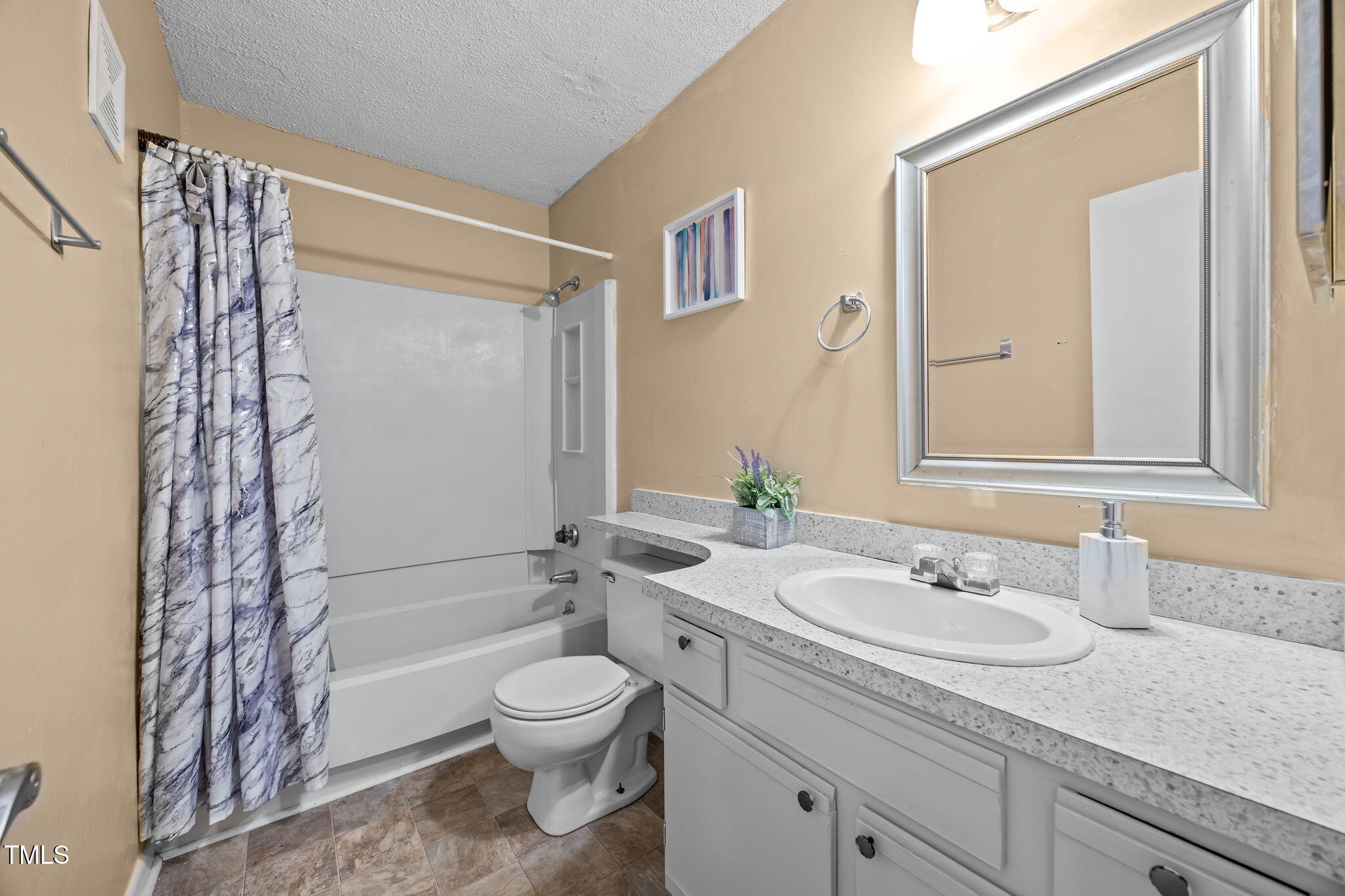 5816 Pointer Drive, Unit 102 Raleigh, NC 27609 - Photo 20 of 25 a bathroom with a sink a toilet and shower