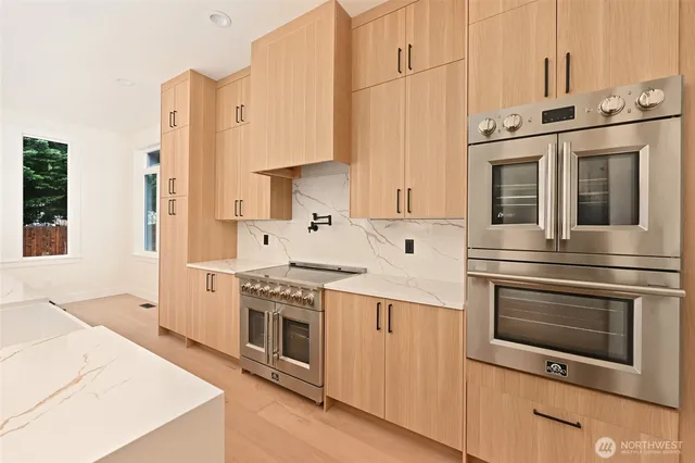 a kitchen with stainless steel appliances granite countertop a stove and a refrigerator