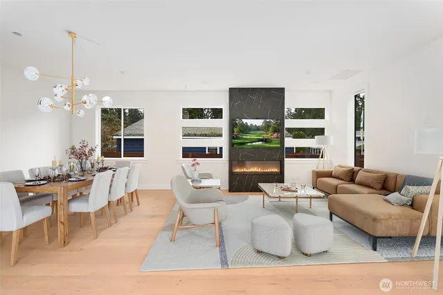 a living room with fireplace furniture and two large window