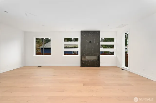 a view of a dining room and livingroom view with furniture wooden floor a chandelier
