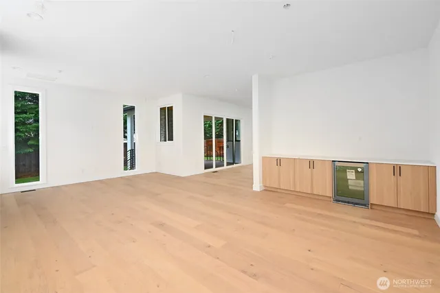 a view of an empty room with closet and window