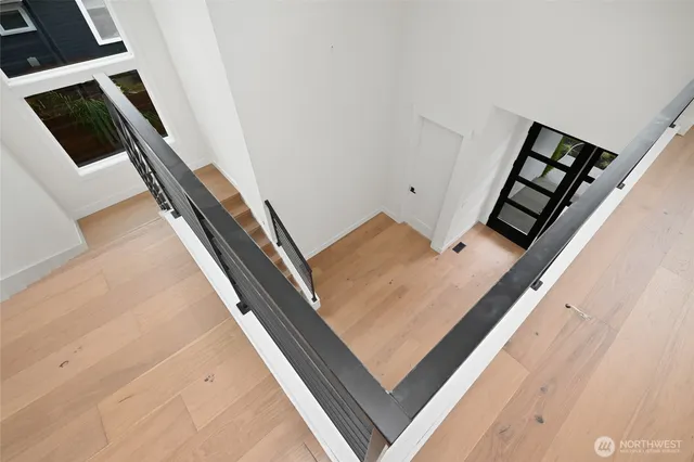 a view of a livingroom with wooden floor and a window