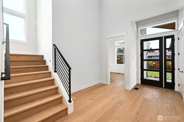 a view of an entryway with wooden floor and door