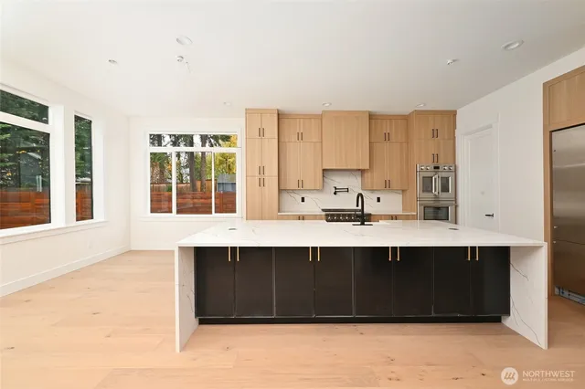 a view of kitchen with stainless steel appliances granite countertop a sink and a stove
