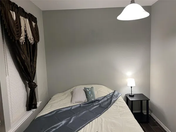 a view of a bedroom with a bed and hardwood floor
