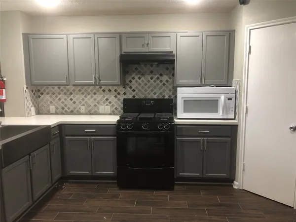 a kitchen with a stove and a microwave