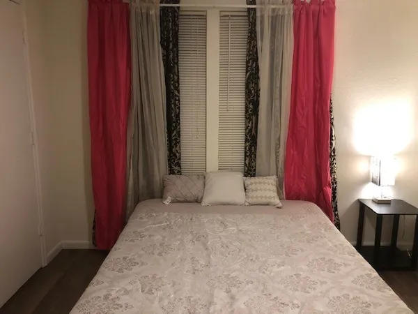 a bedroom with a bed and a window