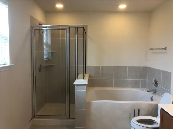 a bathroom with a shower and a bathtub
