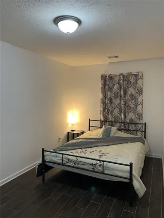 a view of a room with furniture and wooden floor