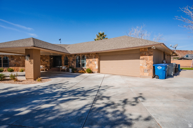 980 Cactus Circle St. George, UT 84790 - Photo 70 of 77 Single story home with stone siding, a garage, concrete driveway, and a shingled roof