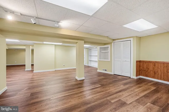 a view of an empty room with wooden floor