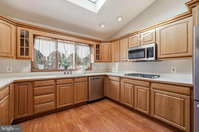 a kitchen with stainless steel appliances granite countertop a stove and a sink
