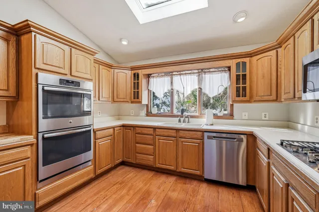 a kitchen with stainless steel appliances granite countertop a refrigerator microwave and stove top oven