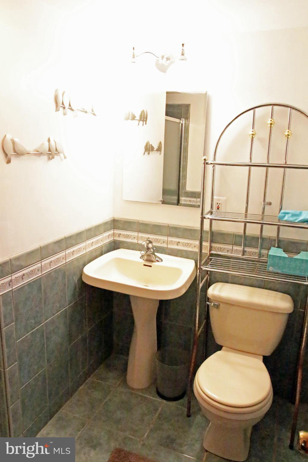 8131 Scotts Level Road Baltimore, MD 21208 - Photo 23 of 29 a bathroom with a sink toilet and mirror