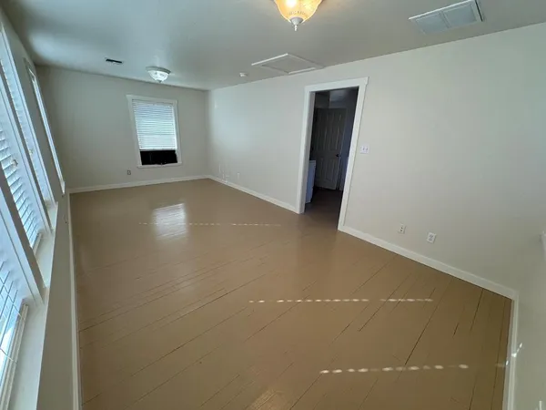 a view of empty room with window and stairs