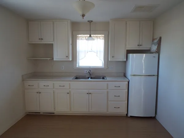 a room with a stove and a wooden floor