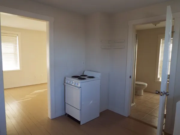 a white toilet sitting next to a shower