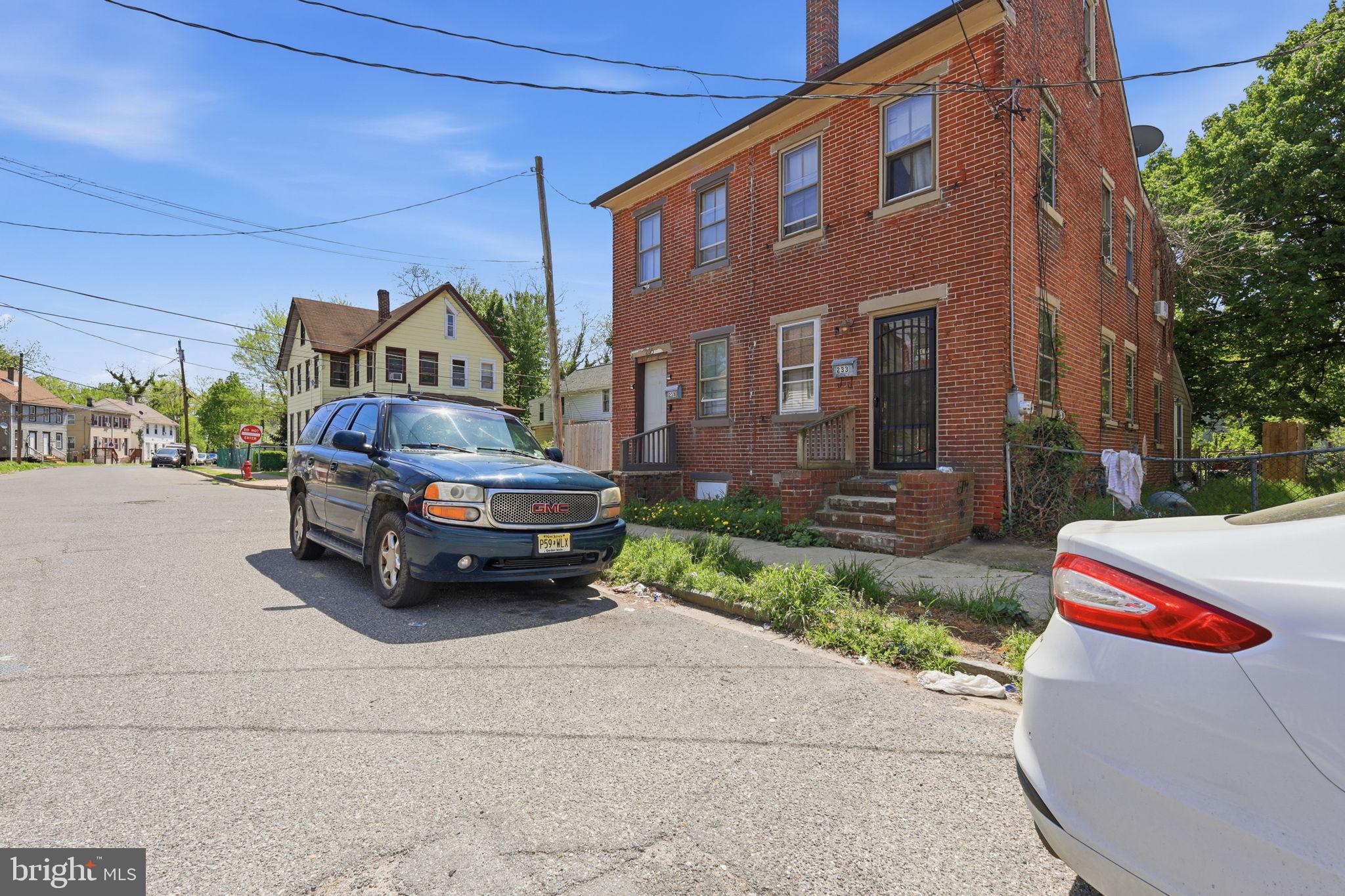 233 Sinnickson Street Salem, NJ 08079 - Photo 4 of 7 a car parked in front of a brick house