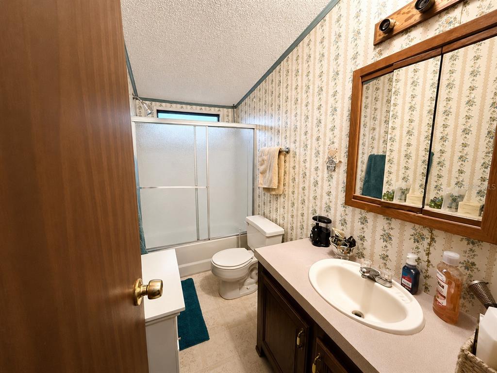 2665 Absher Road St. Cloud, FL 34771 - Photo 25 of 27 a bathroom with a sink toilet and shower