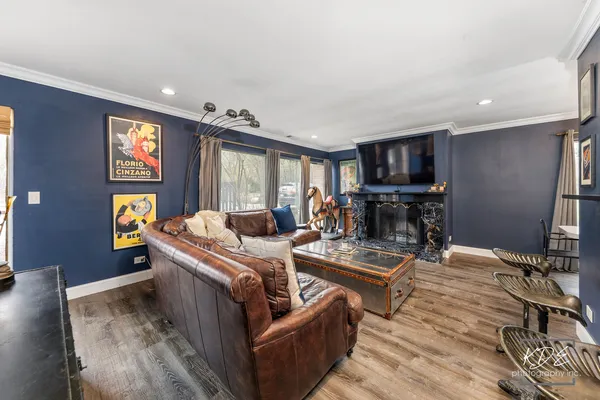 a living room with fireplace furniture and a flat screen tv