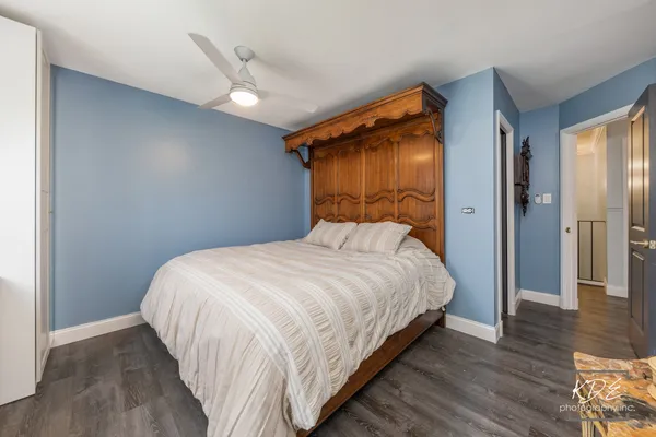 a bedroom with a bed and a ceiling fan