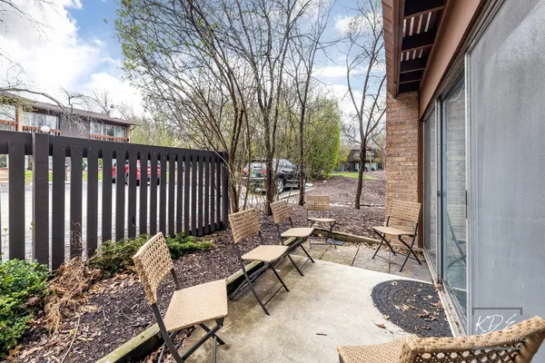 a view of a patio with a table and chairs