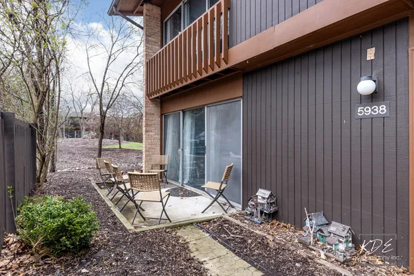 a view of a chairs and table in the backyard