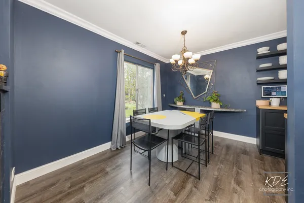 a view of a dining room with furniture wooden floor and chandelier