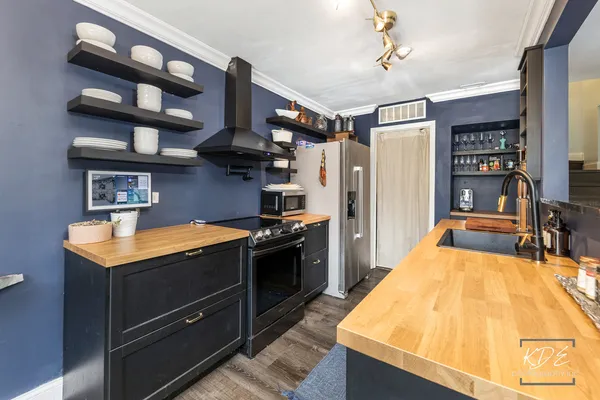 a kitchen with stainless steel appliances granite countertop a stove and a refrigerator