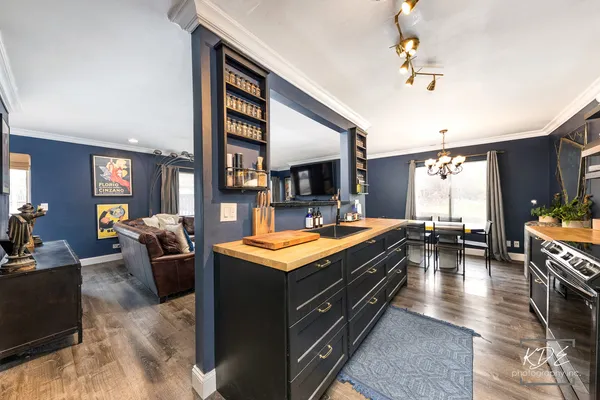a kitchen with sink stove and view living room