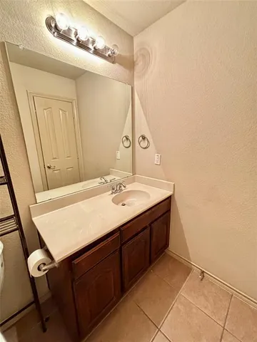 a bathroom with a sink vanity and a mirror