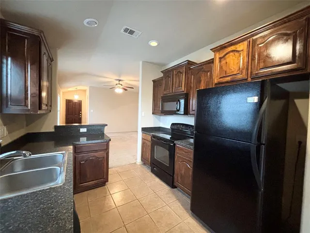 a kitchen with granite countertop lots of counter top space and stainless steel appliances